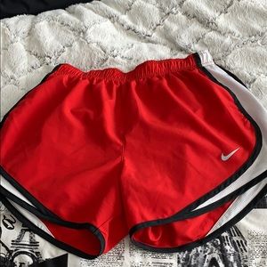 Red and white nike running shorts